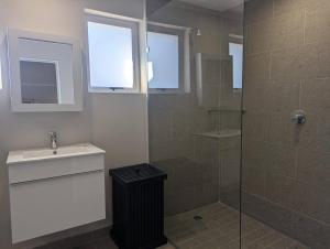 a bathroom with a sink and a glass shower at Potjesberg Lodge in Laudina +4 photos