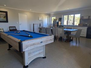 a room with a pool table and a dining room at Potjesberg Lodge in Laudina