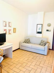 a living room with a couch and a desk at Residence azzurro VISTA MARE-A in Gabicce Mare