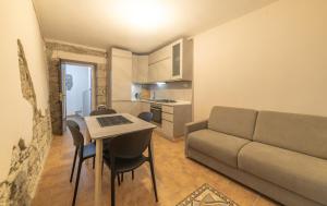 a living room with a couch and a table at Sardinian Gallery S'Iscola in Bosa