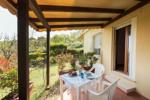 a white table and white chairs on a patio at Residence azzurro VISTA MARE-A in Gabicce Mare