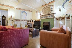 a living room with two couches and a fireplace at Guest house SAL E PEDRA in Villanueva de Arosa