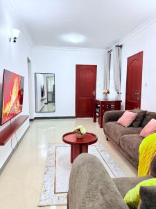 a living room with a couch and a table at Lumora Homes in Arusha