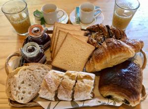 a plate of bread and pastries on a table at Le Chant des Elfes in Samer