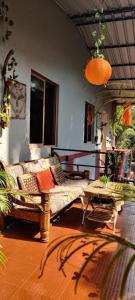 a living room with a couch and a table at Bageecha B&B- V A A Y U in Alībāg +38 photos