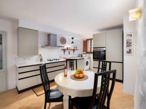 a kitchen with a table with a bowl of fruit on it at Casa Alberi in Volterra