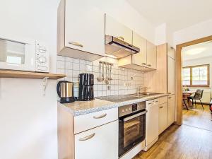 a kitchen with white cabinets and a sink at Apartment Handle-3 by Interhome in Ried im Oberinntal