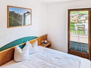 a bedroom with a bed with a large window at Apartment Handle-3 by Interhome in Ried im Oberinntal