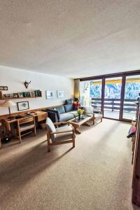 a living room with a couch and a table at Apartment Apt A 086 by Interhome in Disentis