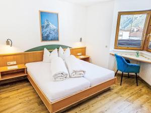 a bedroom with a bed with white pillows at Apartment Handle-2 by Interhome in Ried im Oberinntal