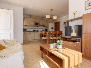 a living room with a table and a kitchen at Holiday Home Flamenc 1 by Interhome in Riumar
