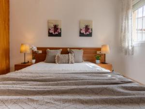 a bedroom with a large bed with two lamps at Holiday Home Flamenc 1 by Interhome in Riumar
