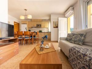 a living room with a couch and a table at Holiday Home Flamenc 2 by Interhome in Riumar