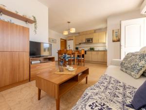 a living room with a couch and a table at Holiday Home Flamenc 2 by Interhome in Riumar