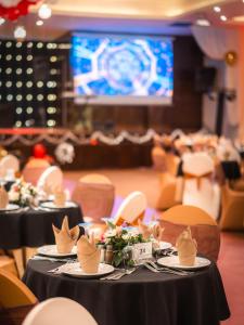 a banquet hall with tables and chairs and a screen at Club Paradisio in Marrakesh +99 photos