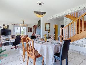 a dining room with a table and chairs at Holiday Home Ty Nevez by Interhome in Sibiril