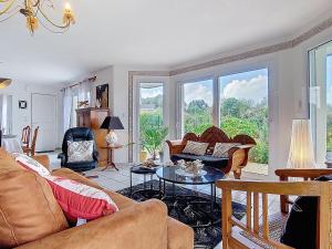 a living room with couches and a table at Holiday Home Ty Nevez by Interhome in Sibiril