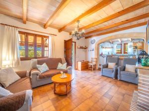 a living room with couches and a table at Holiday Home Can Niu by Interhome in Pollença