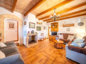 a living room with couches and a fireplace at Holiday Home Can Niu by Interhome in Pollença