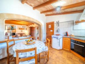 a kitchen and dining room with a table and chairs at Holiday Home Can Niu by Interhome in Pollença +29 photos