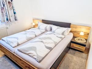 a bed with a wooden headboard in a room at Apartment Christine by Interhome in Prutz