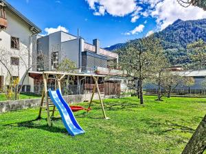 two swings in a yard with a house at Apartment Christine by Interhome in Prutz