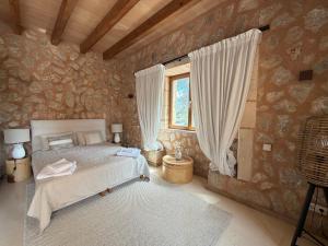 a bedroom with a bed and a window at Finca Latenéa in Islas Baleares