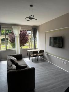 a living room with a couch and a table at Forum View 2 in Durrës