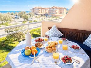 a table with plates of food on top of a balcony at Apartment Port Pals Summer Vibes by Interhome in Pals