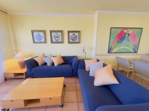 a living room with a blue couch and a table at Apartment Port Pals Summer Vibes by Interhome in Pals