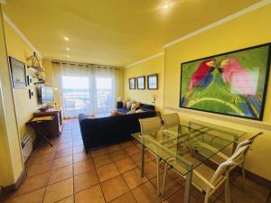 a living room with a couch and a glass table at Apartment Port Pals Summer Vibes by Interhome in Pals +30 photos