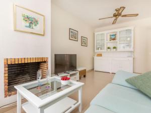 a living room with a couch and a fireplace at Holiday Home Canyadell by Interhome in Torredembarra