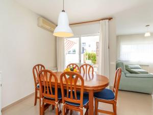 a dining room with a wooden table and chairs at Holiday Home Canyadell by Interhome in Torredembarra