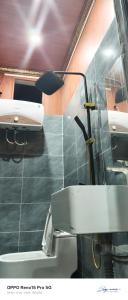 a bathroom with a sink and a light on the wall at A THÁM homestay in Dam Thuy +27 photos