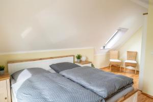 a bedroom with a bed and a staircase with chairs at Ferienwohnung Schultz in Zinnowitz