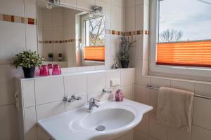 a bathroom with a sink and a mirror at Ferienwohnung Schultz in Zinnowitz +20 photos