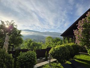 a view of the mountains from the garden of a house at DRUMUL DOMNISORILOR c in Buşteni