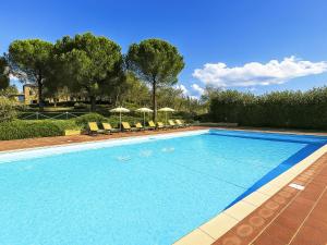 a large swimming pool with chairs and umbrellas at Apartment Monteroni by Interhome in Vergelle