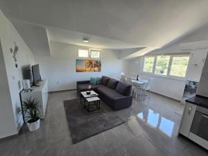 a living room with a couch and a table at Seba Apartments in Korčula