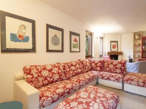 a living room with a red and white couch at Apartment La Marmotta by Interhome in Madesimo +38 photos