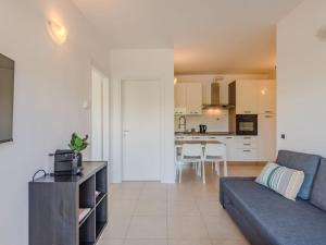 a living room with a couch and a kitchen at Apartment Sole e Fiori by Interhome in Domaso