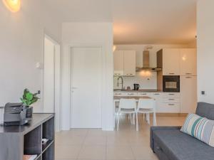 a living room with a couch and a kitchen at Apartment Sole e Fiori by Interhome in Domaso +23 photos