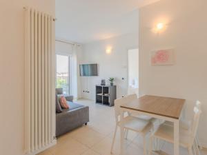 a living room with a table and a couch at Apartment Sole e Fiori by Interhome in Domaso