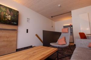 a living room with a table and a couch at iQ-Hotel Ulm in Ulm