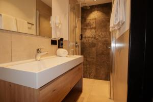 a bathroom with a sink and a shower at iQ-Hotel Ulm in Ulm +45 photos