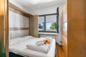 a bedroom with a bed with towels and a window at Grange Studio - Happy Rentals in Grange Sises