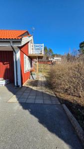 a red building with a balcony on top of it at Attic floor with views over fields and sea in Sigtuna