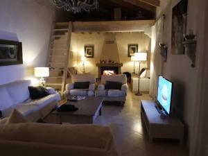 a living room with couches and a tv and a fireplace at El Limonar in Murcia