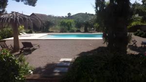 a swimming pool in a yard with a chair at El Limonar in Murcia