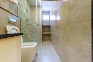 a bathroom with a toilet and a glass shower at Mandala Living Kathmandu in Kathmandu +49 photos